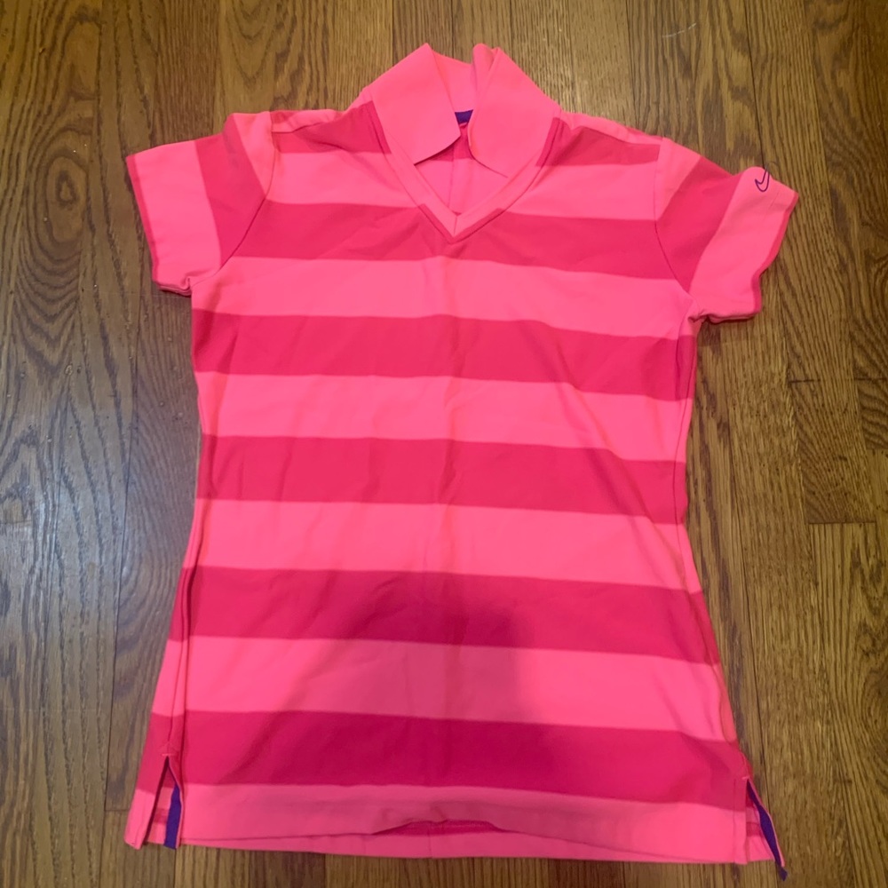 Look cute on the golf course with this Nike tour performance pink shirt.